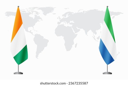 Ivory Coast and Sierra Leone flags for official meeting against background of world map.