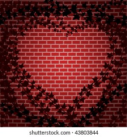Ivy forms a heart shaped frame against brick wall