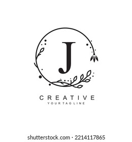 
J letter logo design with floral frame ornaments and circular leaves. the letter J design is beautiful and luxurious. J monogram typography. suitable for beauty, business, company, promotion logo etc