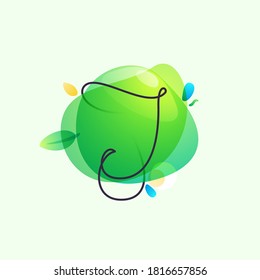 J letter logo placed on green watercolor blots. Overlapping splashes typeface can be used for ecology banner, natural lifestyle poster, vegan identity, etc.