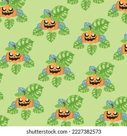 Jack o lantern pumpkin pattern with green and blue monstera leaves.