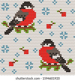 Jacquard knitted seamless pattern with cute bullfinchies, rowanberries and snowflakes. Winter background with nature and birds. Scandinavian style. Vector illustration.