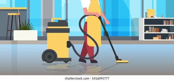 janitor holding professional vacuum cleaner character in uniform cleaning service floor care concept modern co-working office interior horizontal closeup portrait