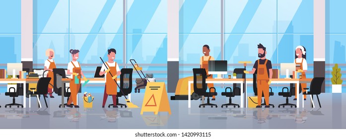 janitors team cleaning service concept male female cleaners in uniform working together with professional equipment modern co-working center office interior flat full length horizontal