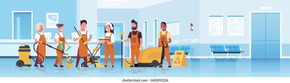 janitors team cleaning service concept mix race cleaners in uniform working together with professional equipment hospital reception interior flat full length horizontal copy space