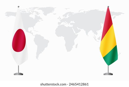 Japan and Guinea flags for official meeting against background of world map.