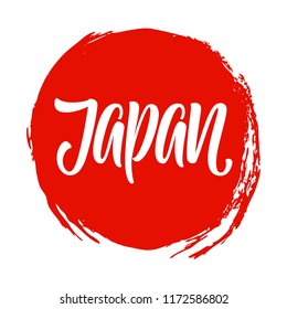 Japan word hand written calligraphy on a red ink painted sun.