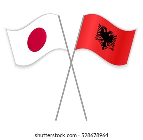 Japanese and Albanian crossed flags. Japan combined with Albania isolated on white. Language learning, international business or travel concept.