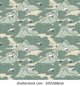 Japanese art inspired seamless pattern of gliding cranes over mountains