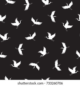 Japanese traditional seamless vector doodle pattern with flying birds cranes silhouette. 