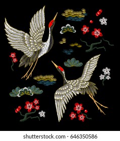 Japanese white cranes with red flowers. Embroidery vector.