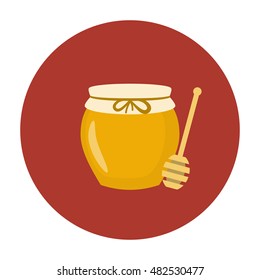 Jar of honey with wooden stick