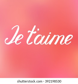 Je taime. I love you in French. Handwritten words illustration, hand made brush lettering on a lovely blurred background.