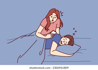 Jealous woman reads SMS in phone of boyfriend sleeping in bed and spies on husband checking incoming calls. Jealous wife does not trust partner due to relationship problems or regular cheating