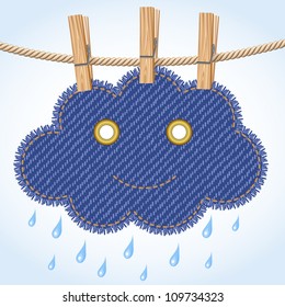 Jeans rain cloud with a cute smile hanging on a clothesline