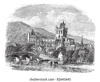 Jedburgh Abbey in Scotland, during the 1890s, vintage engraving. Old engraved illustration of Jedburgh Abbey with lake and bridge in front.  Trousset encyclopedia (1886 - 1891). svg