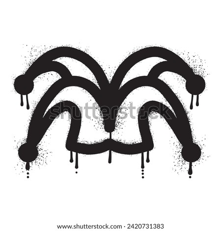 Jester hat graffiti drawn with black spray paint