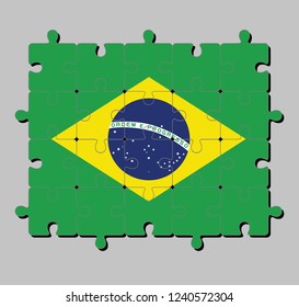 Jigsaw puzzle of Brazil flag in green yellow and blue color and world in center. Concept of Fulfillment or perfection.