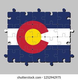 Jigsaw puzzle of Colorado flag in blue white and blue. On top of these stripes sits a circular red “C”. The states of America, Concept of Fulfillment or perfection.