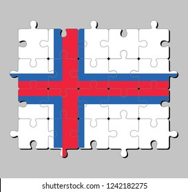 Jigsaw puzzle of Faroe Islands flag in a blue-fimbriated red Nordic cross on a white field. Concept of Fulfillment or perfection.