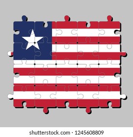 Jigsaw puzzle of Liberia flag in eleven horizontal stripes of red and white with white star on a blue. Concept of Fulfillment or perfection.
