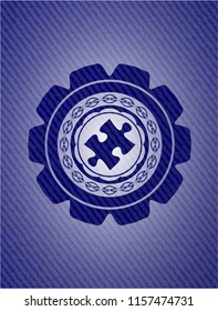jigsaw puzzle piece icon inside jean or denim emblem or badge background