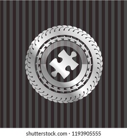 jigsaw puzzle piece icon inside silver emblem or badge