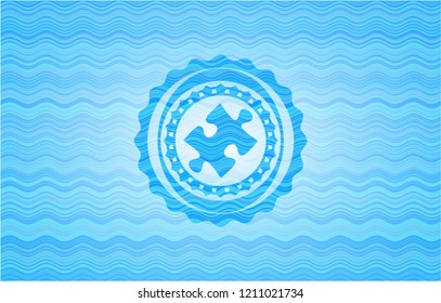 jigsaw puzzle piece icon inside light blue water style emblem.