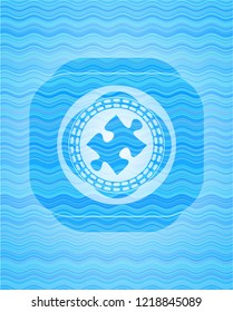 jigsaw puzzle piece icon inside water concept emblem background.