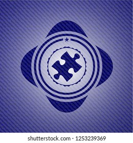 jigsaw puzzle piece icon inside badge with jean texture