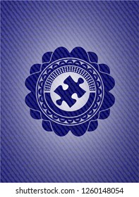 jigsaw puzzle piece icon inside emblem with jean texture