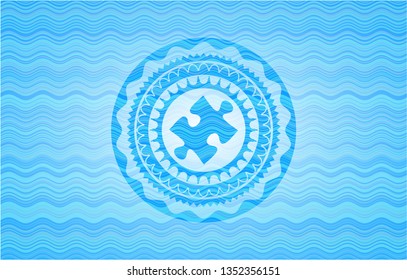 jigsaw puzzle piece icon inside water wave style emblem.