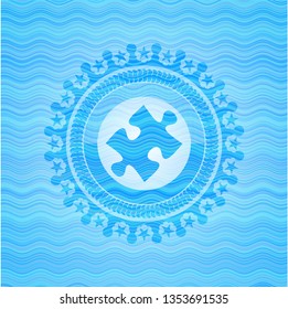 jigsaw puzzle piece icon inside sky blue water wave emblem.
