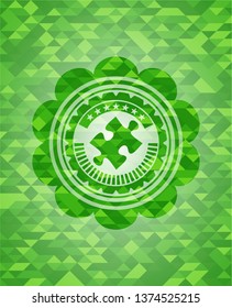 jigsaw puzzle piece icon inside green emblem with triangle mosaic background