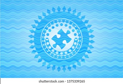 jigsaw puzzle piece icon inside sky blue water wave style emblem.