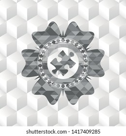 jigsaw puzzle piece icon inside grey emblem with geometric cube white background