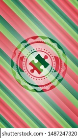 jigsaw puzzle piece icon inside christmas colors emblem.