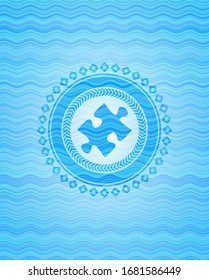 jigsaw puzzle piece icon inside water wave emblem.
