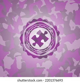 jigsaw puzzle piece icon on pink camouflaged pattern. 