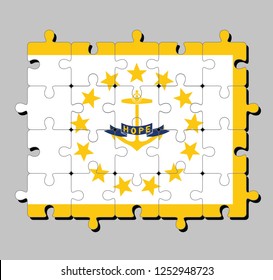 Jigsaw puzzle of Rhode Island flag in Gold anchor, surrounded by 13 gold stars. A blue ribbon below the anchor contains the text "hope". The states of America.