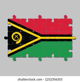 Jigsaw puzzle of Vanuatu flag in red and green with black and yellow color boar's tusk encircling two crossed fern fronds and the golden pall. Concept of Fulfillment or perfection.