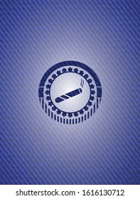 joint, cigarette icon inside badge with denim background
