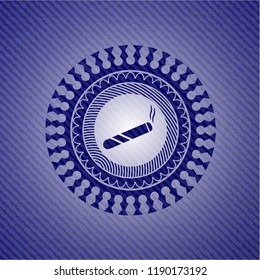 joint, cigarette icon inside emblem with jean background