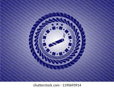 joint, cigarette icon inside emblem with jean background