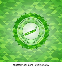 joint, cigarette icon inside green emblem with triangle mosaic background. 