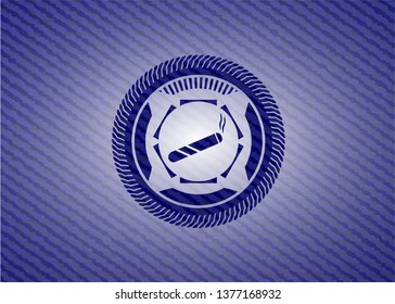 joint, cigarette icon inside jean or denim emblem or badge background