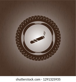 joint, cigarette icon inside wooden emblem
