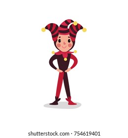 Joker flat cartoon character standing with arms akimbo. Boy clown in black and red costume. Jester or festival fool wear with cap and bells. Comedy artist. Circus worker. Vector isolated on white.