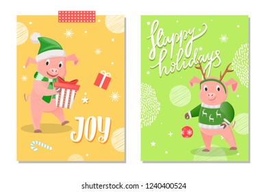 Joy and Happy Holidays greeting cards. Smiling pig holding gift in green hat and scarf, piggy in winter sweater with decoration of deer on head vector