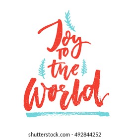 Joy To The World. Christmas Greeting Card With Brush Calligraphy. Handmade Typography For Gift Tags. Vector Red Text With Blue Hand Drawn Branches